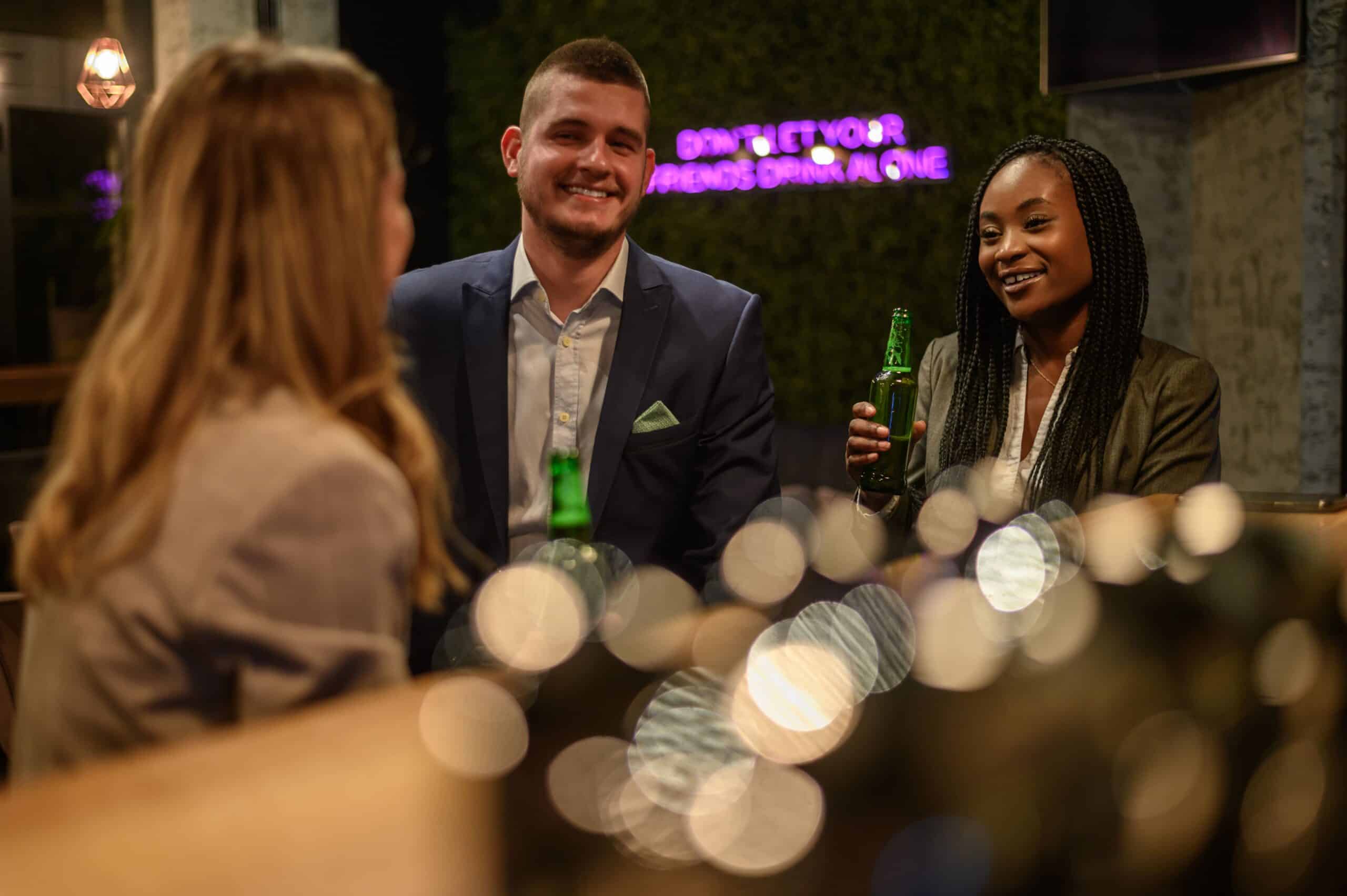 cheerful colleagues drinking beer in the bar toget 2023 11 27 04 59 17 utc min